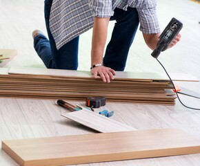 Man laying flooring at home