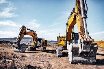 Group of yellow excavator working on construction open mining site