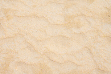 Fototapeta na wymiar Sand texture as background in summer sun