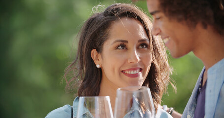 Obraz premium Romantic young woman and man tasting wine having degustation at vineyard winery.Wine tasting.Red wine tasting people enjoy drinking.Close up.Woman looking to man with wine glass smiling