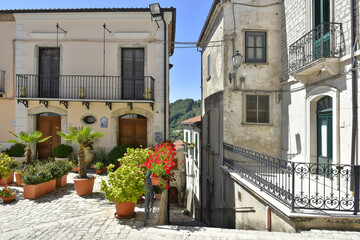 Fototapeta na wymiar A narrow street among the old houses of Santa Croce del Sannio, a rural village in the Campania region.