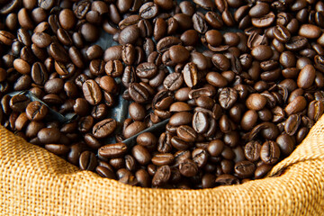close up of roasted coffee beans in brown sack