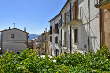Fototapeta na wymiar A narrow street among the old houses of Santa Croce del Sannio, a rural village in the Campania region.