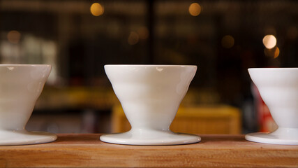 white ceramic cups against blurry background