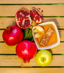 Traditional foods of Rosh HaShana - Jewish New Year: a bowl of honey with the honeycomb,  apples...