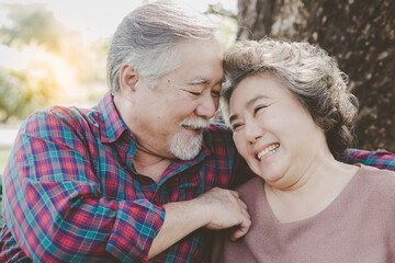 Portrait romantic senior couple. Old man and old woman looking each other and lauging together at park with love. Elderly husband Older wife are eternal love. Gray hair man and female has good health