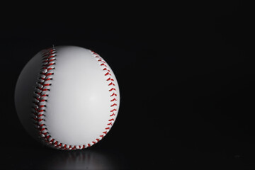 American traditional sports game. Baseball. Concept. Baseball ball and bats on a black table.