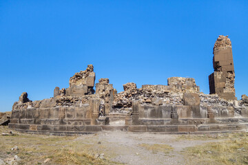 Fototapeta na wymiar Front view onto remains of King Gagik's church of St Gregory in medieval city Ani, near Kars, Turkey. It was built in 1005, ruined during conquests & earthquakes. Now it's UNESCO object