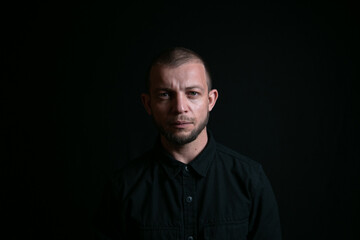 Emotional man portrait on black background