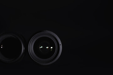 Optics to the camera on the operator’s desk. Flare in the glass of a photo lens. Background with the technique of the photographer.