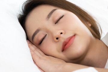 Fototapeta na wymiar Asian women sleeping and sweet dream on white bed in bedroom
