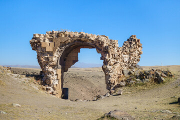 Remains of gate's arch in medieval ghost town Ani, near Kars, Turkey. Gate located on top of...