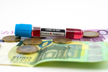Euro money banknotes,coins and coronavirus (covid-19) blood sample