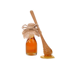 Honey and wooden dipper isolated on white background