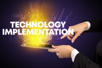 Close-up of a touchscreen with TECHNOLOGY IMPLEMENTATION inscription, innovative technology concept