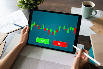 Online Trading Currency Forex Stock Market concept on screen with Economic graphs Candle chart and SELL and BUY buttons.