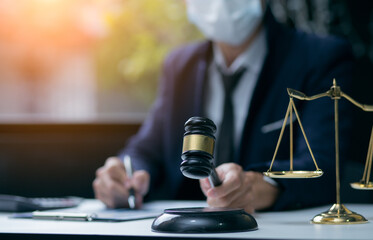Fototapeta na wymiar Male lawyer or judge wearing protective mask on the consult having team meeting with client, Law and Legal services concept