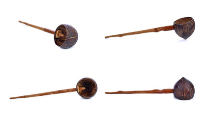 Water ladle made from coconut shell, placed on a white background.