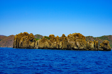 Fototapeta na wymiar an island of volcanic lava on the high seas