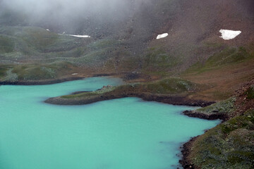 Alpine lake in the clouds. Alpine lake Giybashkel (3240 meters above sea level), Pastushiy pass...