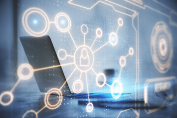 Computer on desktop with social network hologram. Double exposure. Concept of international people connections.