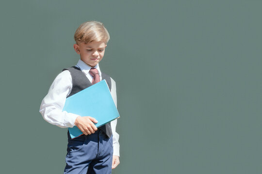 A little boy in full dress uniform is preparing for school