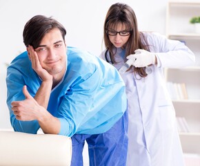 Funny man getting ready for buttocks syringe shot