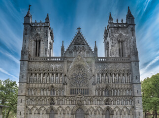 Fototapeta na wymiar The imposing facade of the Nidaros Cathedral, Trondheim, Trondelag, Norway. Built 1070-1300 AD in romanesque and gothic styles over the burial site of St. Olav. Consecration site for Norwegian kings