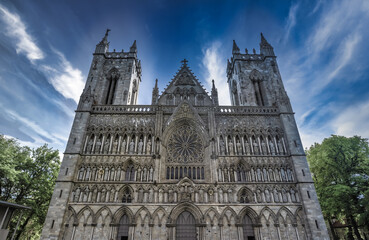 Fototapeta na wymiar The imposing facade of the Nidaros Cathedral, Trondheim, Trondelag, Norway. Built 1070-1300 AD in romanesque and gothic styles over the burial site of St. Olav. Consecration site for Norwegian kings