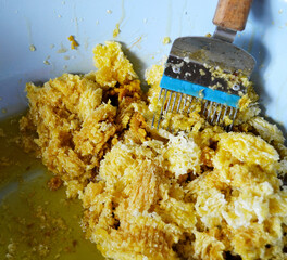 Drop of bee honey drip from hexagonal honeycombs