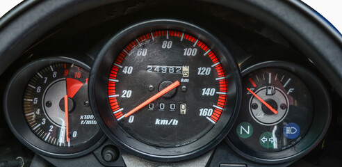 Vehicle dashboard meter cluster with speedometer, fuel gauge and RPM meter.