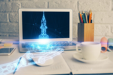 Desktop computer background in office and start up theme hologram drawing. Double exposure. Startup...