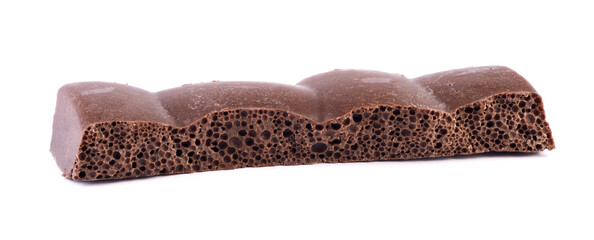 Porous chocolate bar closeup on white background. Chocolate piece isolated