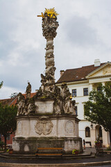 Fototapeta premium Magnificent baroque column in Sopron, Hungary. Holy trinity statue. Religious architecture. Artistic object. Travel destination.