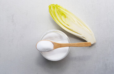 Green chicory with inulin powder. Healthy food concept.