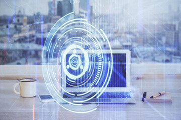 Double exposure of desktop computer and technology theme hologram. Concept of software development.