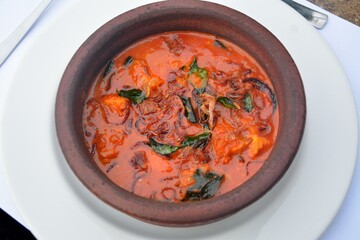 Mahi Keralan fish curry served in a clay pot in Kochi Fort, Cochin, India