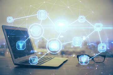 Computer on desktop with social network hologram. Multi exposure. Concept of international people connections.