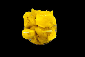 Creative Close Up Macro, Top View of Ripe Pineapple Pieces On Isolated White Background. Fresh juicy yellow fruit slices in glass bowl in healthy food pattern. Clipping Path With Copy Space For Text.