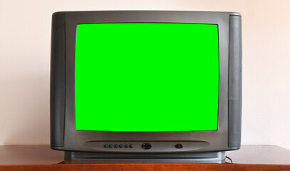 Old black vintage TV with green screen to add new images to the screen.
