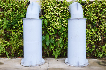 urban and nature pipes with leaves in background