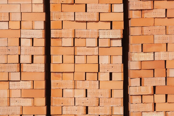 Close up many orange block bricks are stacked together