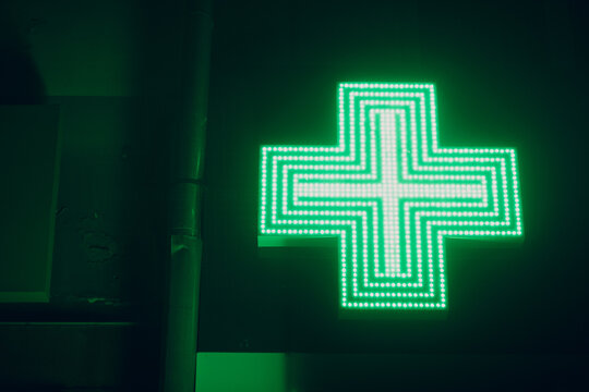 Green Cross Sign on a Building of Pharmacy