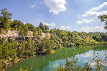 A picturesque lake located in a former basalt quarry. Pure water and wonderful nature. Basalt Columns. Rivne oblast. Ukraine