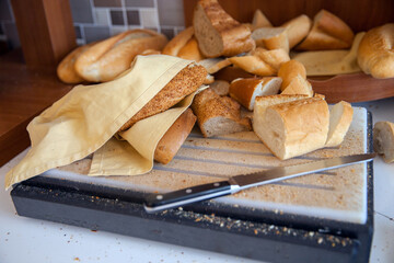 A cutting board with bread on self service table