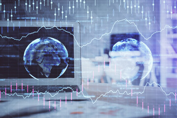 Forex market graph hologram and personal computer on background. Multi exposure. Concept of...