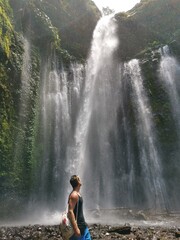 Guy in front of a waterfall in Lombok - taking a break and refreshing