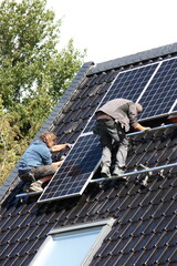 Dachdecker bei der Montage einer Fotovoltaikanlage auf dem Dach in Lippetal Büninghausen an der...