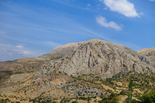 Panoramic view onto Taurus mountains, near Kahta, Eastern Turkey. Massive mountain formation with empty top surrounded by rare forest. Photo taken near famous mount Nemrut