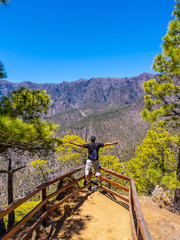 A young tourist at the Mirador Lomo de las Chozas de La Cumbrecita on the island of La Palma next to the Caldera de Taburiente, Canary Islands. Spain © unai
